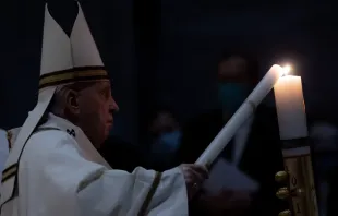 Pope Francis lights a candle at the Easter Vigil Mass in St. Peter's Basilica on April 3, 2021. Credit: EWTN News/Daniel Ibáñez/Vatican Pool